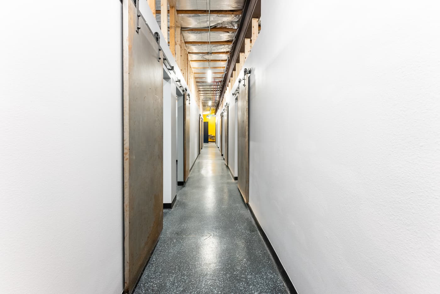 The corridor of private suites at Certified Tattoo Suites, 3725 Drennan Road, Colorado Springs