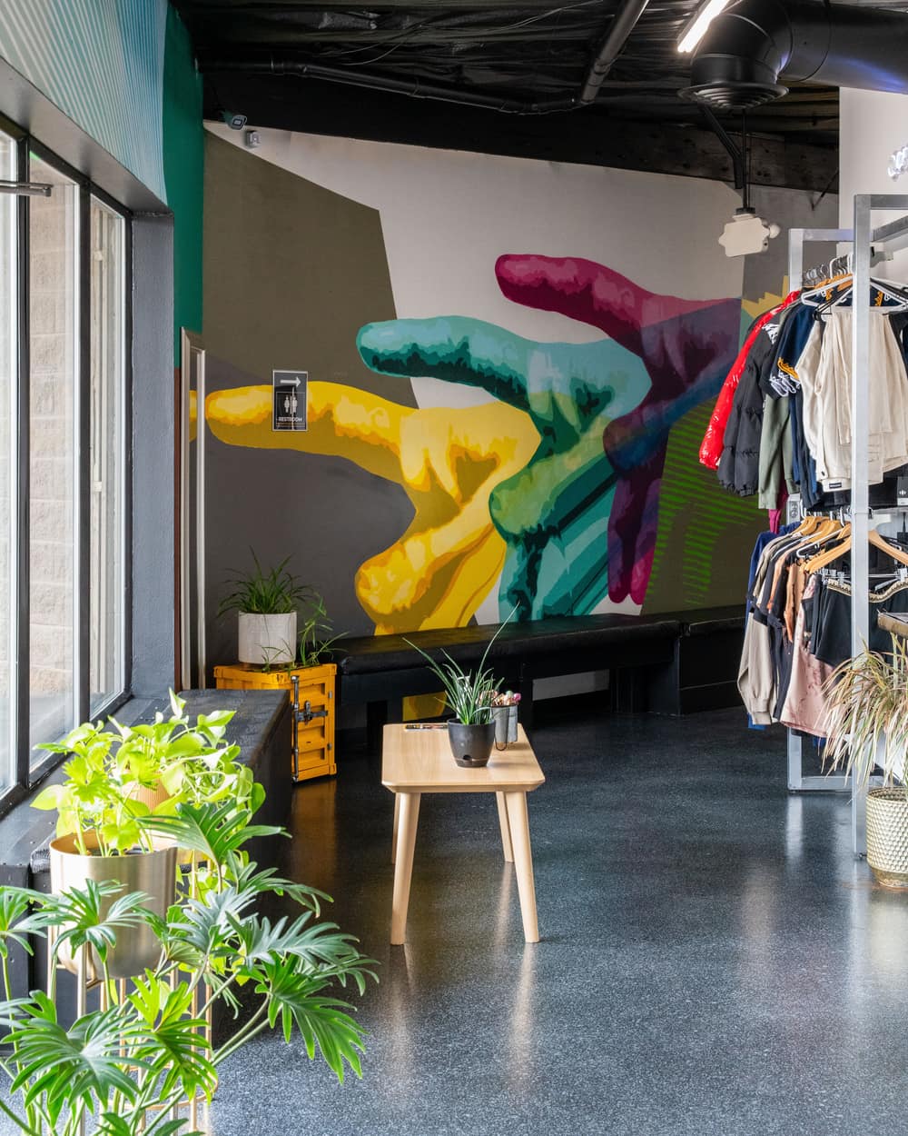 The lobby at 3725 Drennan Road with the hand mural, plants and the merch rack